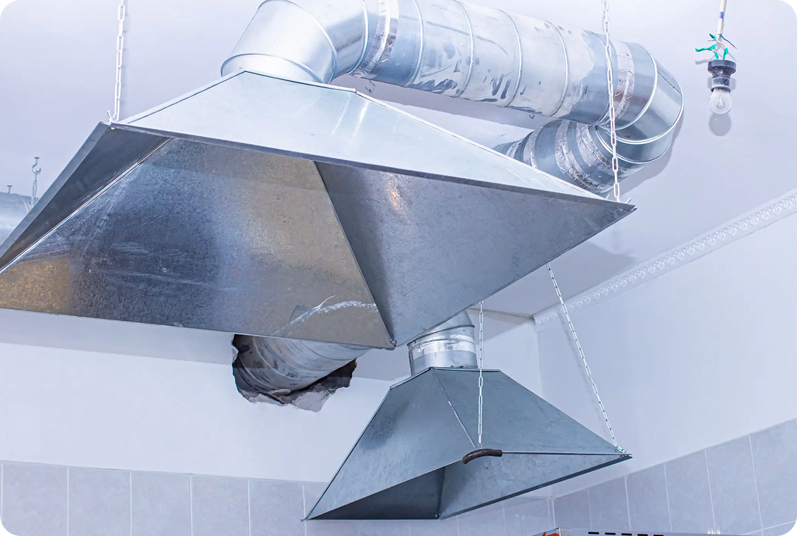 Metallic air ducts and vents on ceiling.