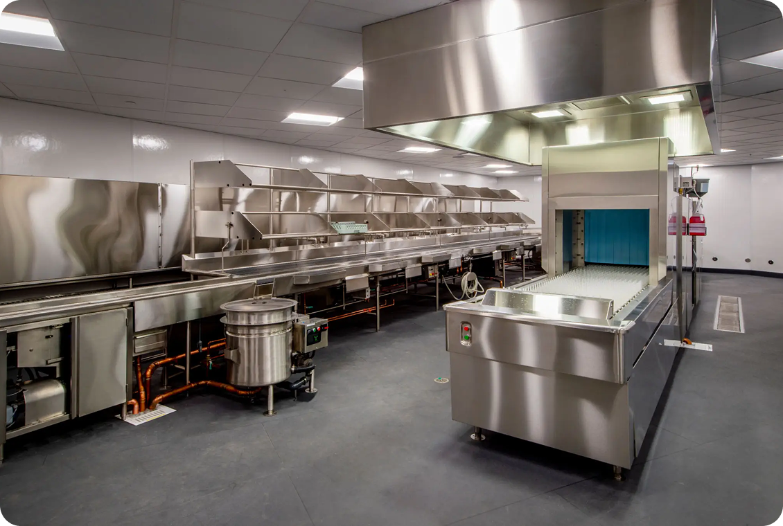 Commercial kitchen with stainless steel equipment.